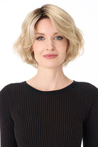 Gia by Envy chin-length blonde bob wig with textured layers and soft volume on a model.