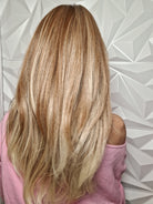 Woman wearing long layered wig (Henry Margu's Milan in color 88GR) back