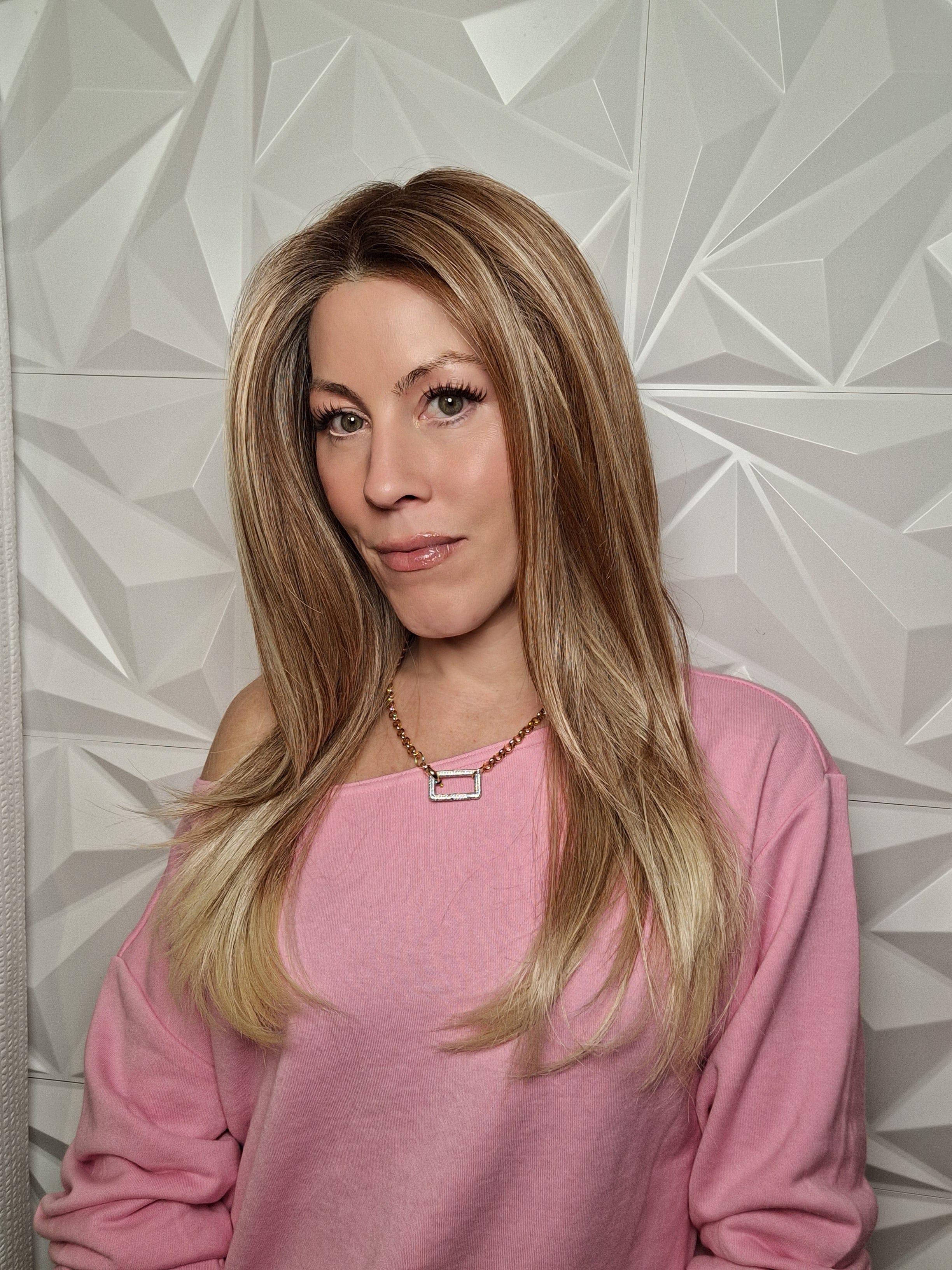 Woman wearing long layered wig (Henry Margu's Milan in color 88GR)