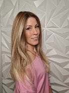 Woman wearing long layered wig (Henry Margu's Milan in color 88GR)