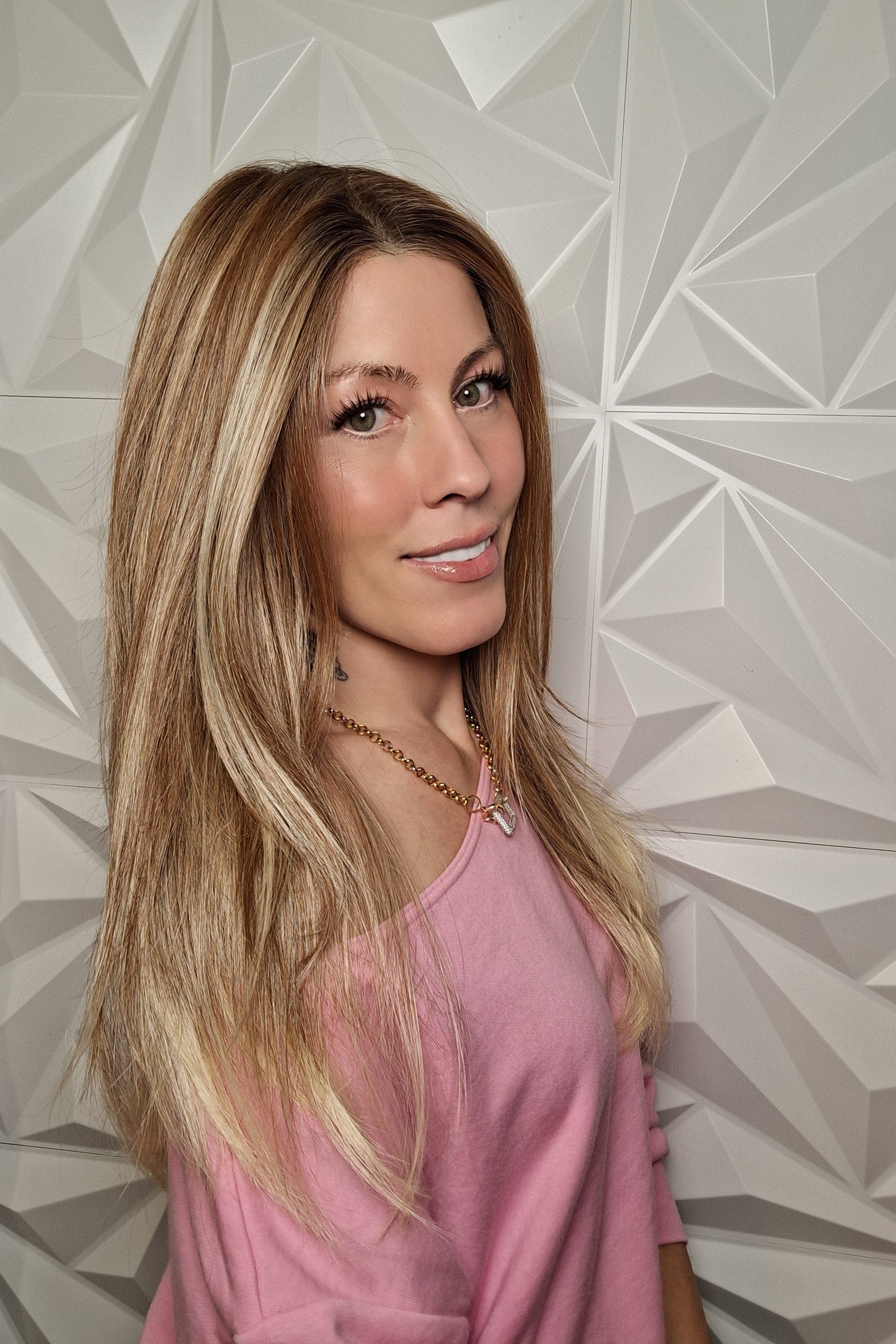 Woman wearing long layered wig (Henry Margu's Milan in color 88GR)