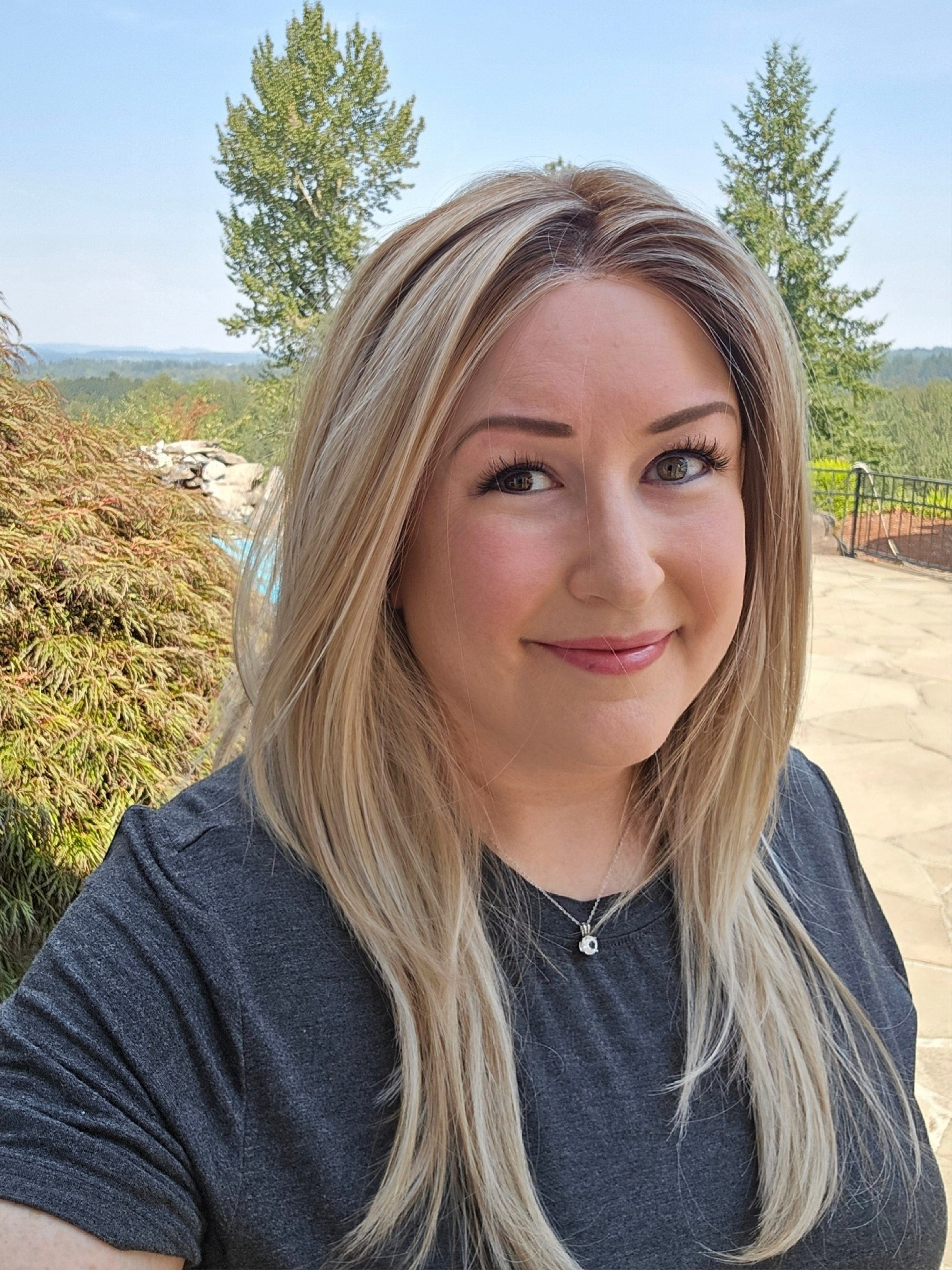 Woman wearing long layered wig (Henry Margu's Milan in color 10/613GR)