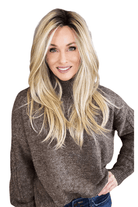 Woman wearing long layered wig (Henry Margu's Milan in color 26GR)