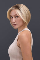 Woman with a stylish haircut against a dark background