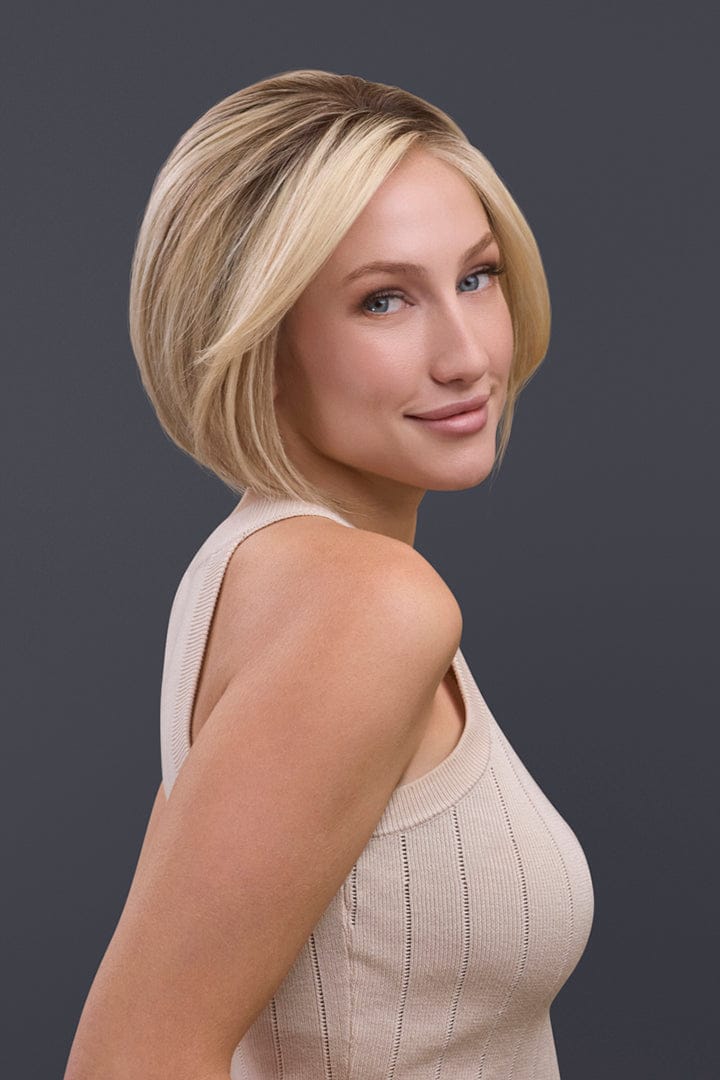 Blonde Remy human hair Ignite Petite bob wig with lace front and monofilament top, styled on a woman.