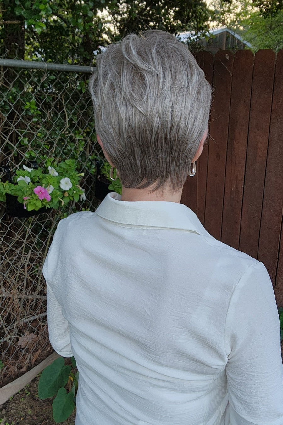 Woman wearing short gray pixie wig (Celine by Jon Renau in Oyster)