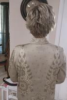 Woman wearing cropped pixie wig (Jon Renau's Chelsea in color Shaded Praline) back