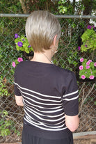 Woman wearing classic blonde pixie wig (Tess by Jon Renau in Martini)
