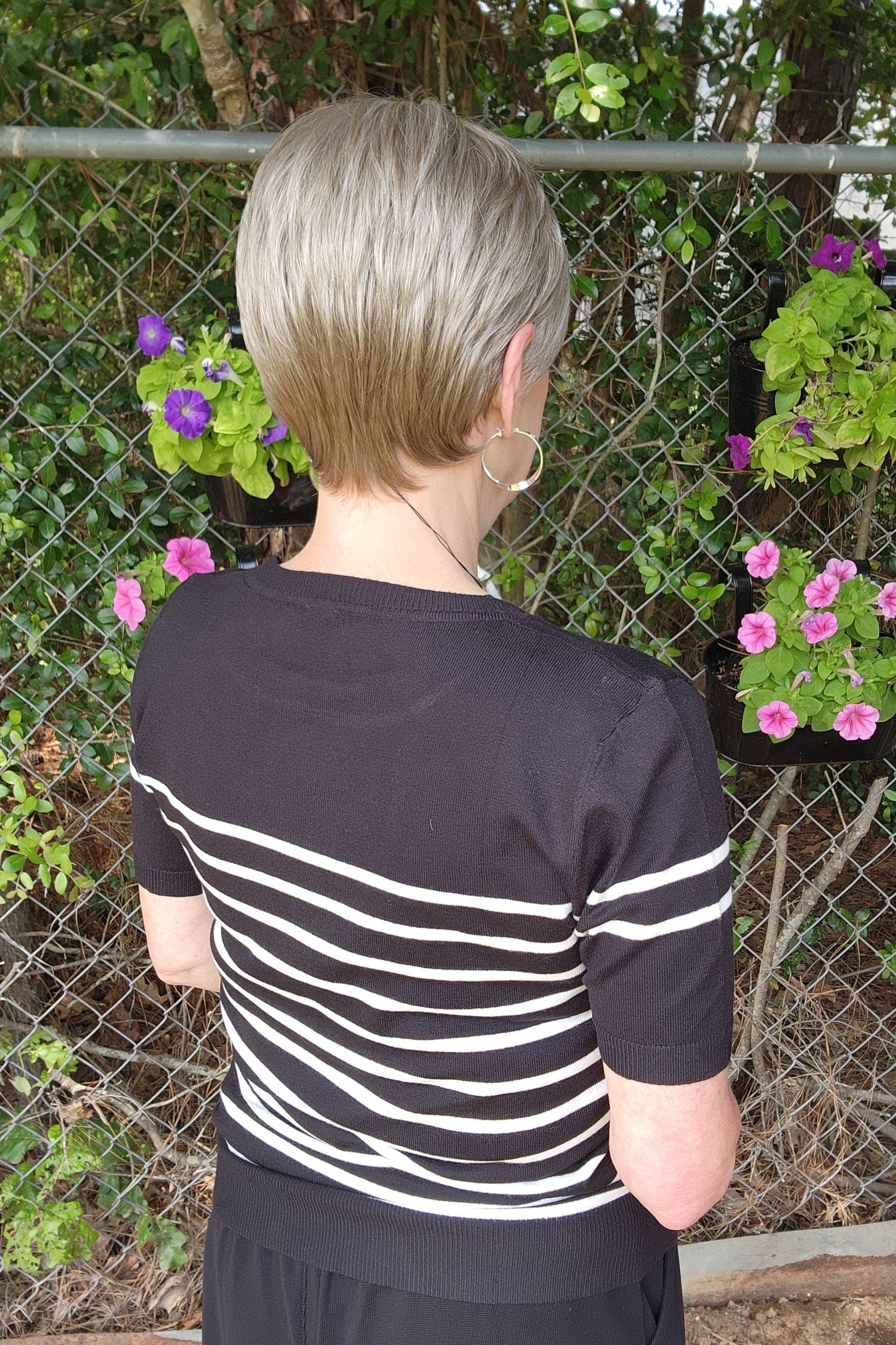 Woman wearing classic blonde pixie wig (Tess by Jon Renau in Martini)