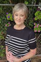 Woman wearing classic blonde pixie wig (Tess by Jon Renau in Martini)