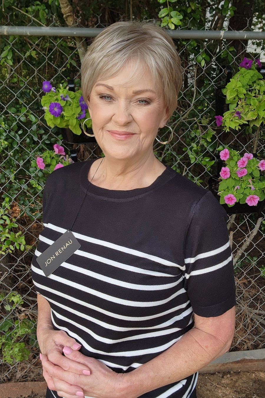 Woman wearing classic blonde pixie wig (Tess by Jon Renau in Martini)