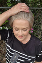 Woman wearing classic blonde pixie wig (Tess by Jon Renau in Martini)