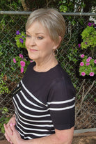 Woman wearing classic blonde pixie wig (Tess by Jon Renau in Martini)