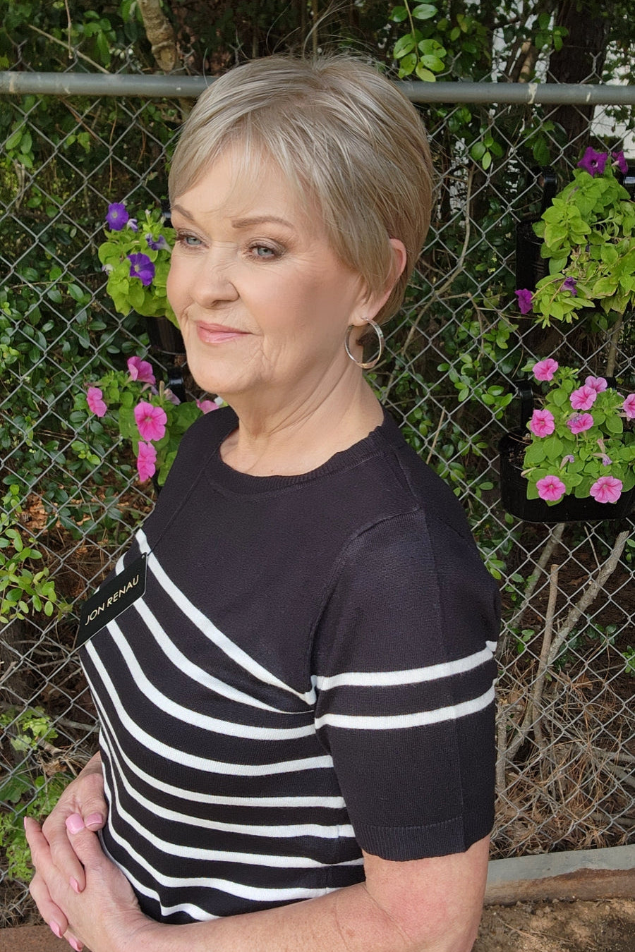 Woman wearing classic blonde pixie wig (Tess by Jon Renau in Martini)