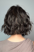 A woman with short dark brown wig (January by Jon Renau in color Mocha Latte R)