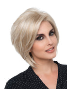 Woman wearing chin-length platinum blonde bob wig (Juliet by Envy in color Light Blonde)