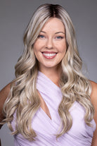 Karenina by Belle Tress long blonde wavy synthetic wig with a natural lace front and monofilament top.