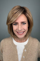 Woman wearing blonde bob with bangs (Meadow by Henry Margu in 12/26GR).