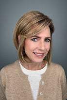 Woman wearing blonde bob with bangs (Meadow by Henry Margu in 12/26GR).