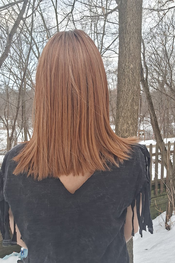 Woman wearing shoulder-length red wig (Megan by PUSH Hair in color Pumpkin Pie Spice R)