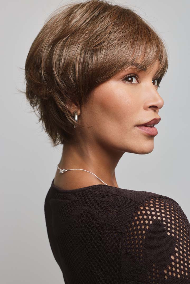 Mio by Noriko short layered brown pixie wig with a lace front and monofilament part on a woman.