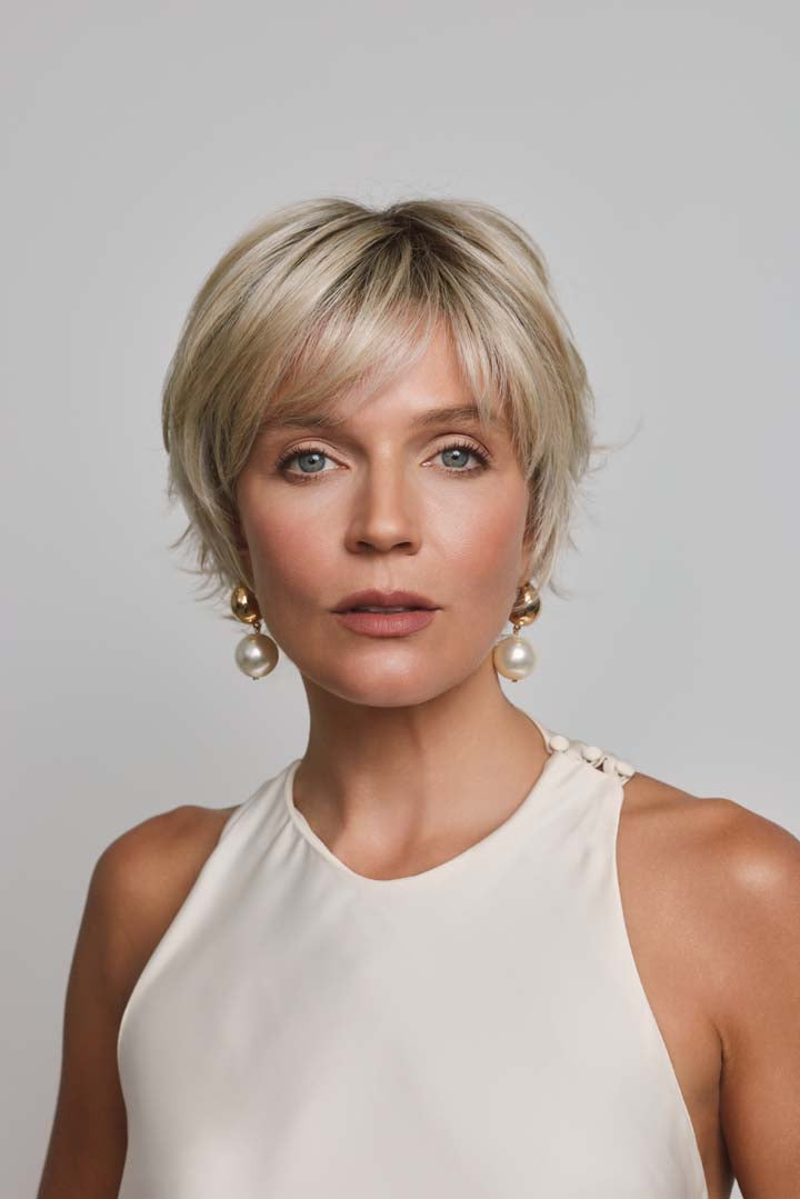 Mio by Noriko short blonde layered pixie wig with a lace front and monofilament part on a woman.