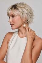 Mio by Noriko short blonde layered pixie wig with a lace front and monofilament part on a woman.