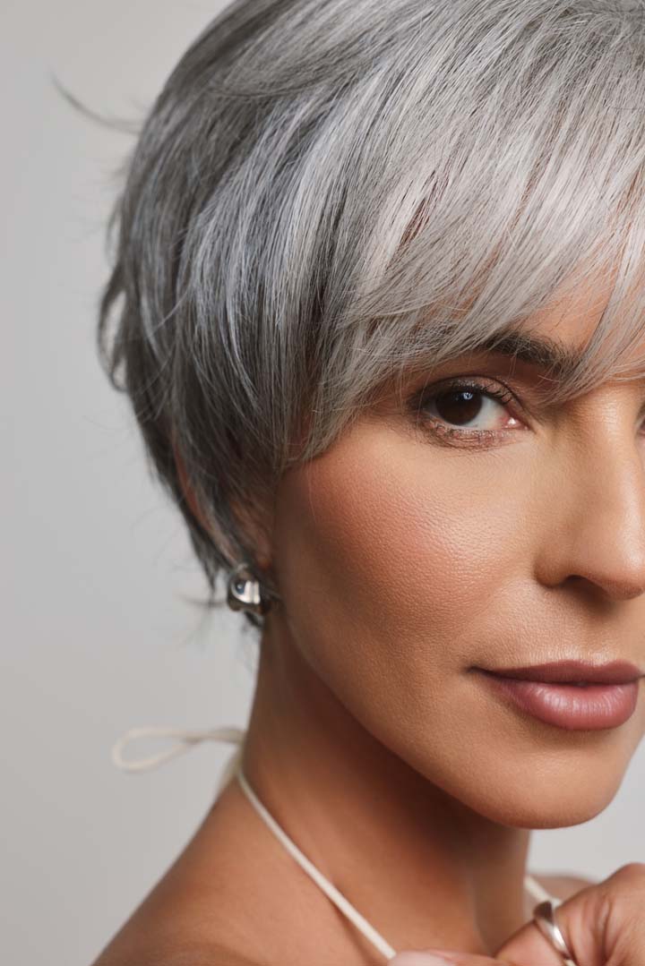 Mio by Noriko synthetic silver-grey short layered pixie wig with a natural lace front and side-swept fringe.