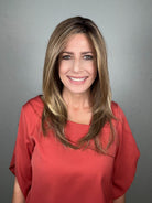 Woman wearing long layered wig (Mirror Moment by Gabor in Honey Pecan)