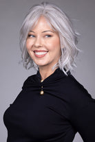 Woman wearing Naples wig by Belle Tress in Oyster Gray | Side smiling