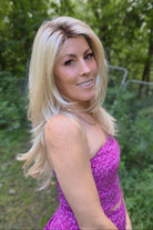 A woman with long blonde layered wig (Angelica by Noriko in Champagne R).