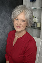 A woman with short gray bixie wig (Mio by Noriko in color Silverstone).