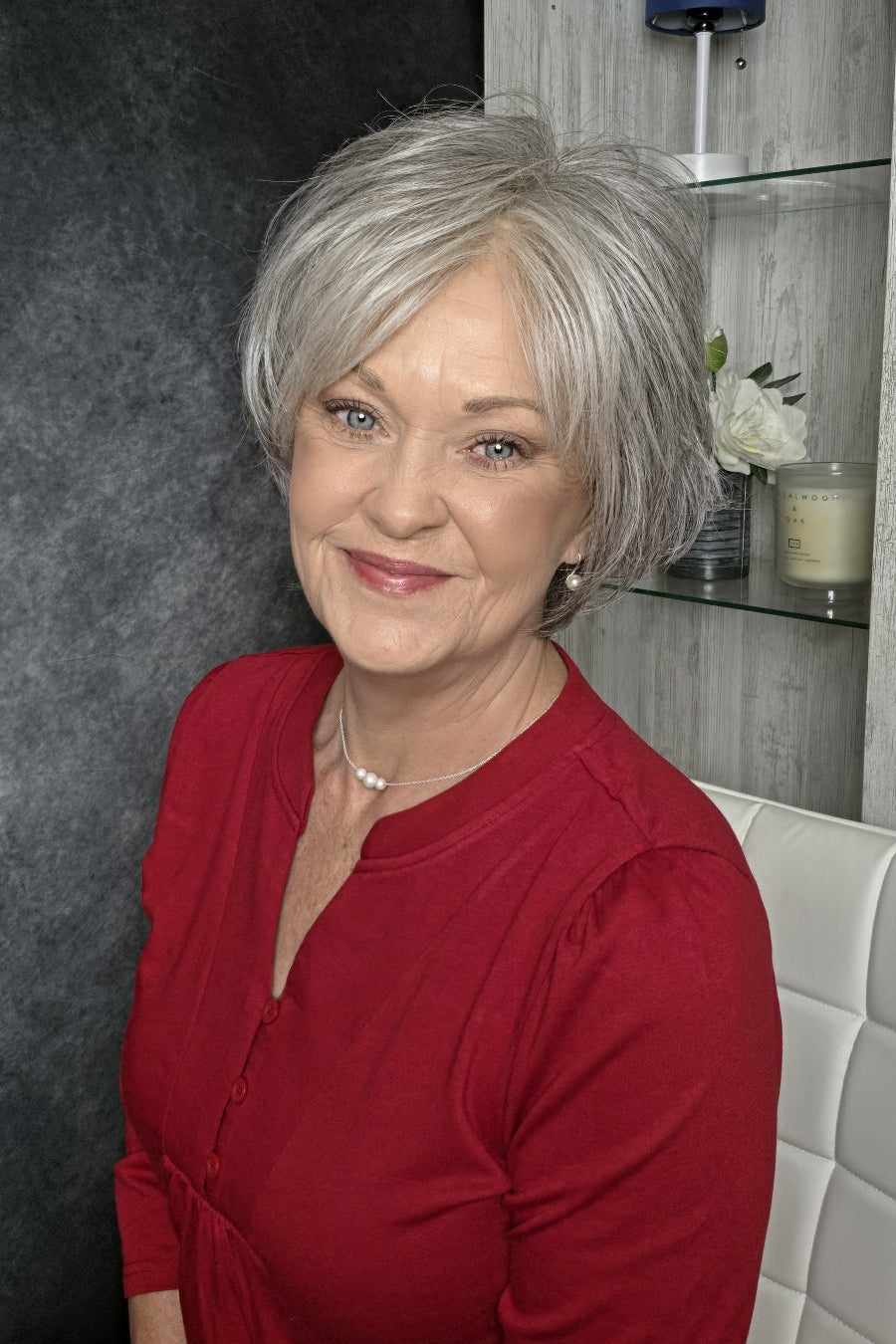 A woman with short gray bixie wig (Mio by Noriko in color Silverstone).