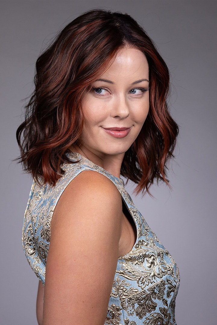 Orchid by Belle Tress shoulder-length wavy bob wig with money piece highlights and a center part.
