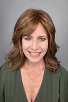 Woman wearing shoulder length brunette wig with bangs (Raquel Welch's On My Way wig in color Honey Toast)