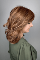 Woman wearing shoulder length brunette wig with bangs (Raquel Welch's On My Way wig in color Honey Toast) back