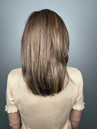 Woman with shoulder-length brown layered wig with side bangs (Own the Room by Gabor in Shaded Iced Cafe Latte)
