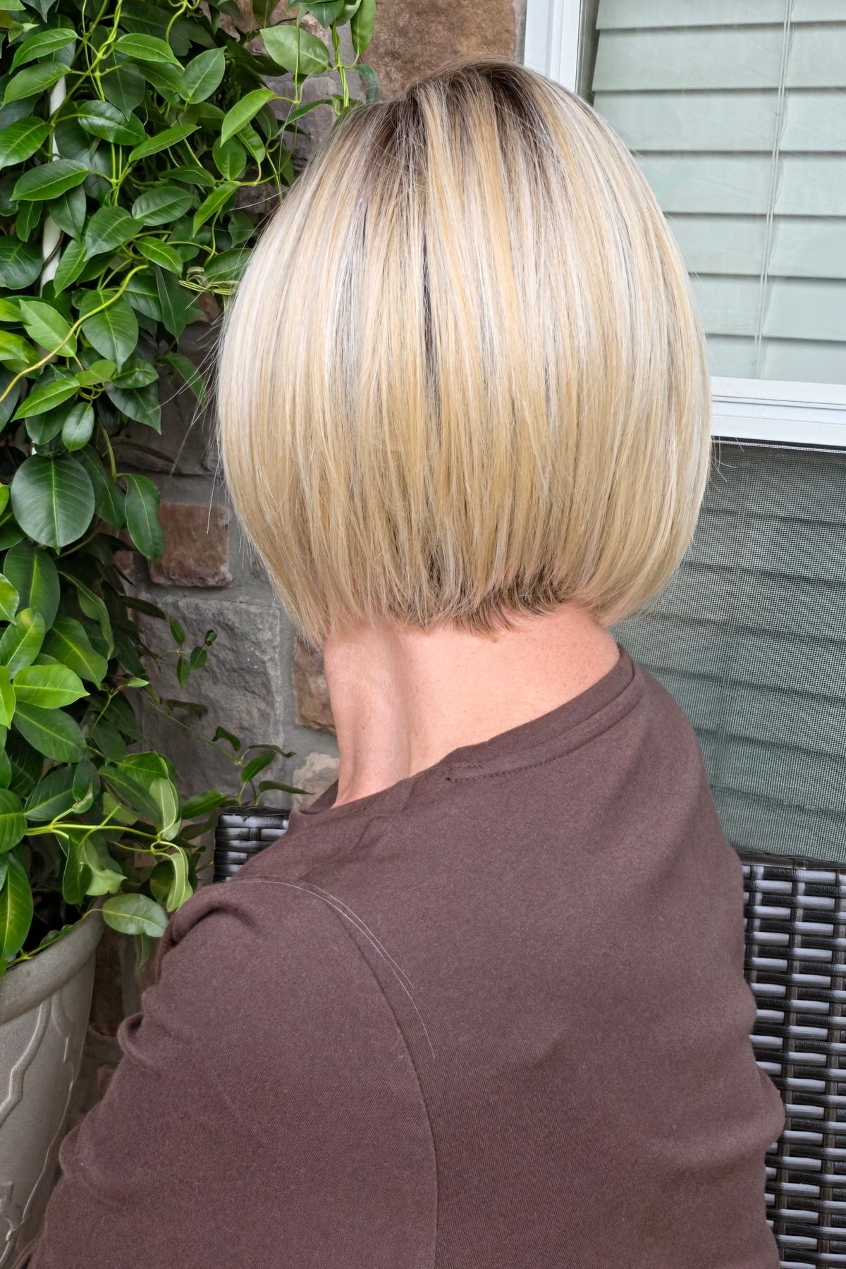 A woman with a chin-length blonde bob wig (River by PUSH Hair in Biscotti Blonde R).