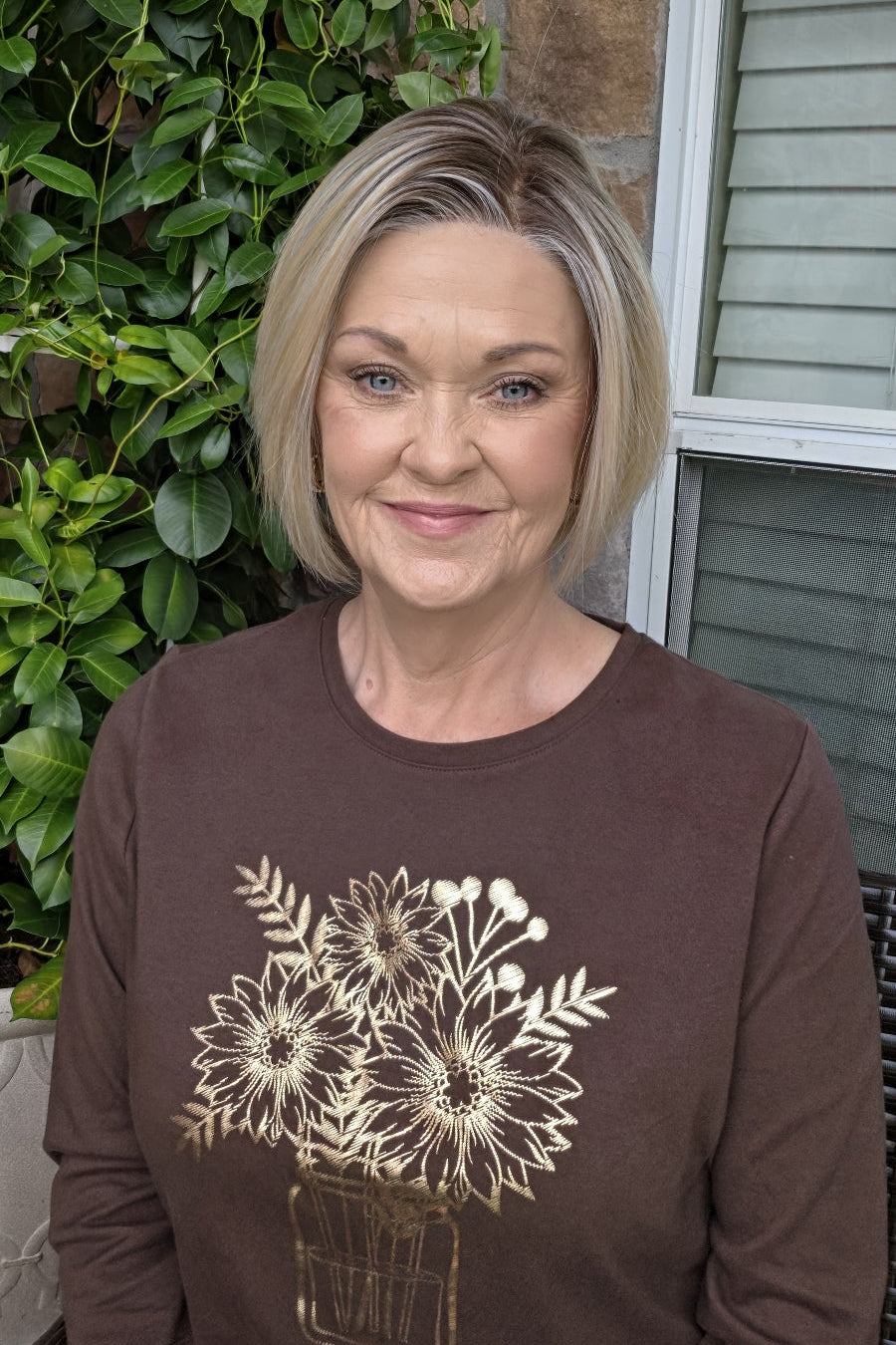 A woman with a chin-length blonde bob wig (River by PUSH Hair in Biscotti Blonde R).