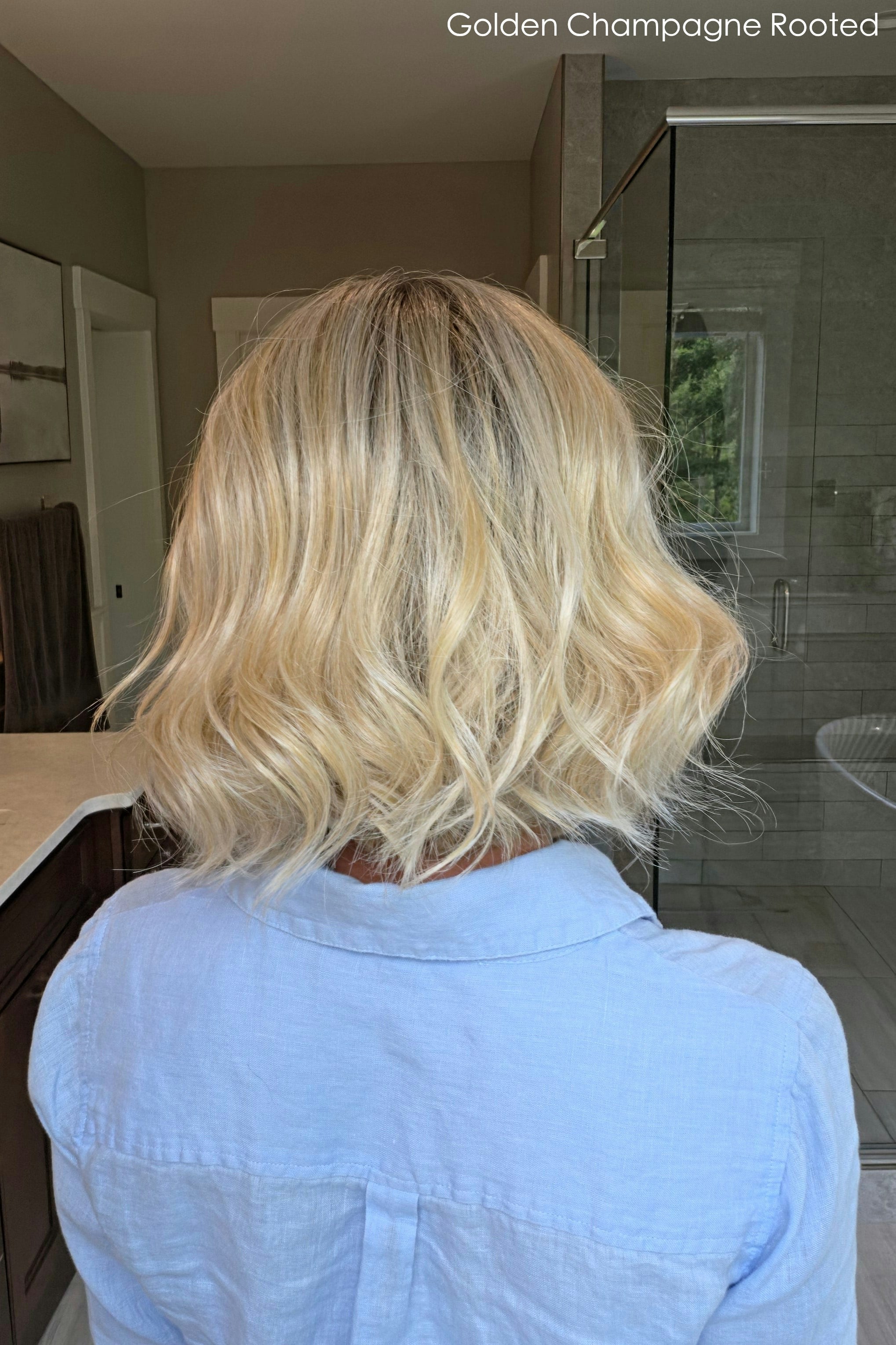 Woman wearing shoulder length curly blonde wig (Brielle by PUSH Hair in color Golden Champagne R)