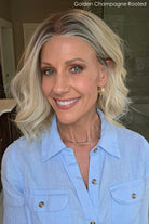 Woman wearing shoulder length curly blonde wig (Brielle by PUSH Hair in color Golden Champagne R)