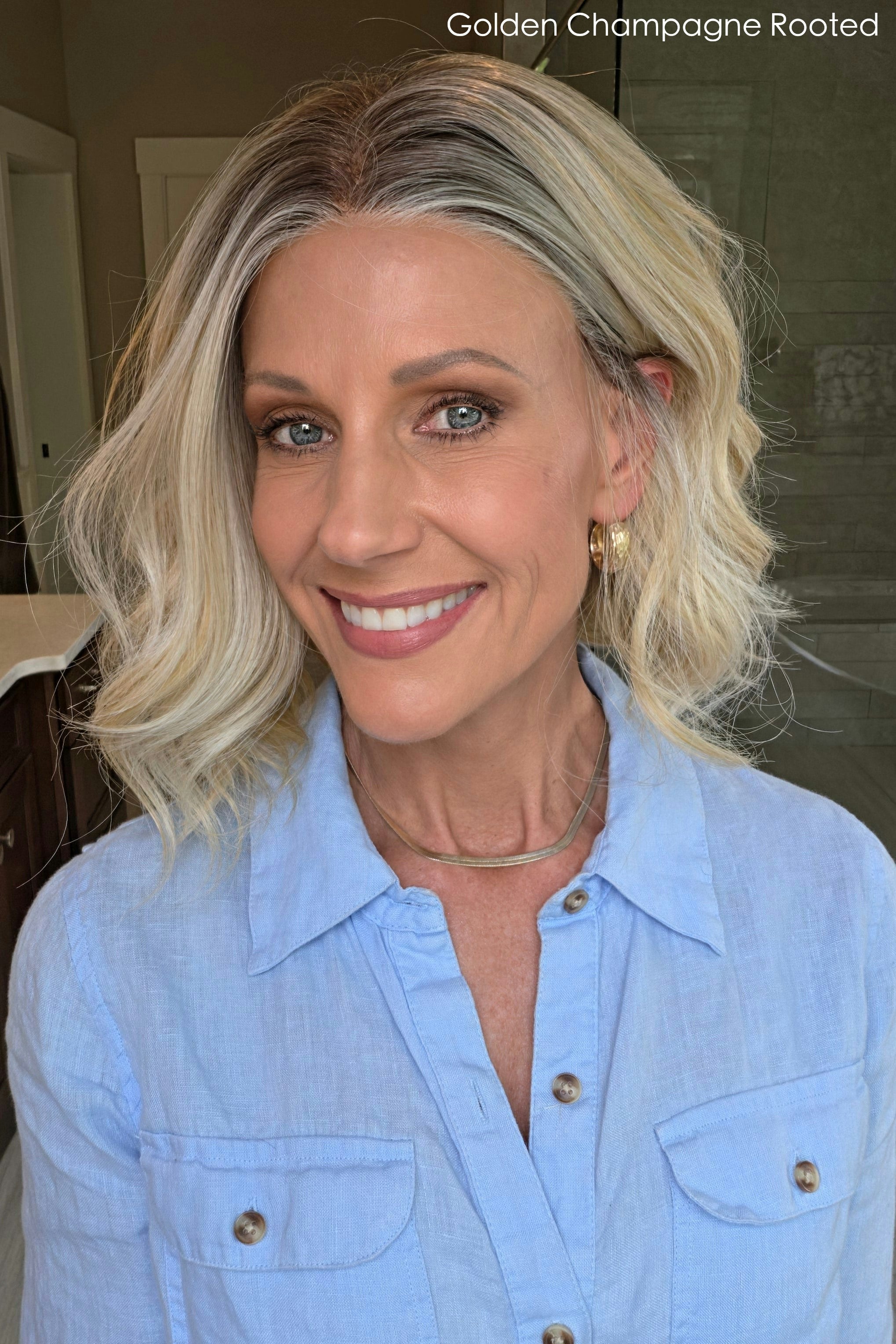 Woman wearing shoulder length curly blonde wig (Brielle by PUSH Hair in color Golden Champagne R)