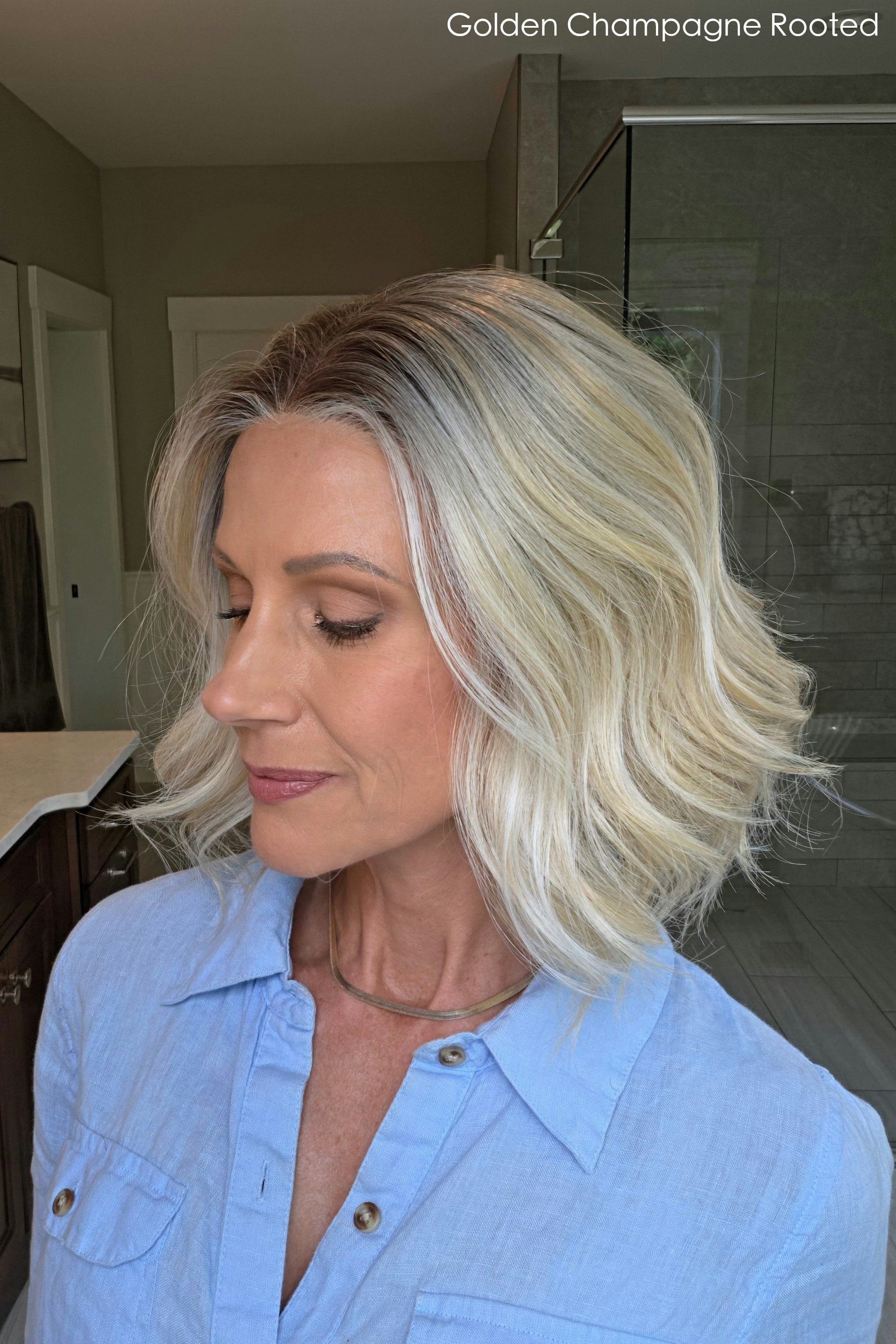 Woman wearing shoulder length curly blonde wig (Brielle by PUSH Hair in color Golden Champagne R)
