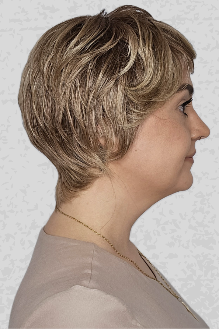Woman with short blonde hair wearing PUSH Hair's Camille in color Shadow Champagne against a light background, side profile
