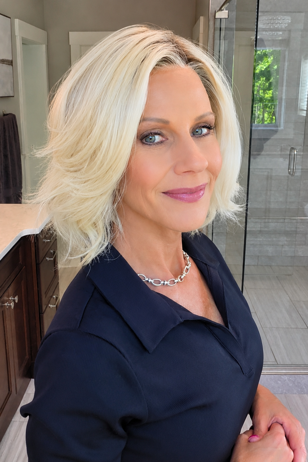 Woman wearing platinum blonde bob wig (Yvette by PUSH Hair in Bombshell Blonde). 