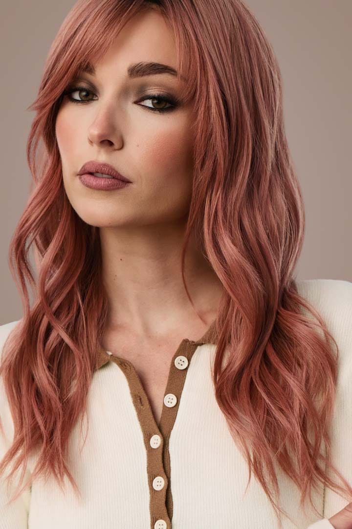 Woman in Posh Wavez Dusty Rose wig