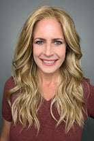 Woman with long blonde wavy wig (Posh Wavez by Rene of Paris in color Creamy Toffee)