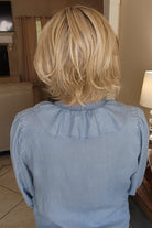 Woman wearing a blonde wavy bob wig (Brann by Rene of Paris in Seasalt Blonde R)
