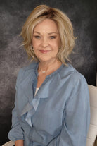 Woman wearing a blonde wavy bob wig (Brann by Rene of Paris in Seasalt Blonde R)