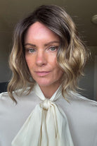 Woman wearing angled bob hair topper (Rene of Paris' Evanna Topper in Mochaccino LR)
